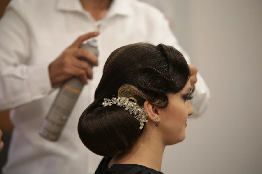 An elegant special-occasion updo being finished
